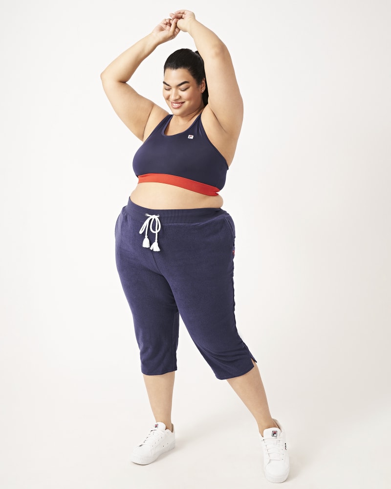 Plus size model with hourglass body shape wearing Sydney Cropped Joggers by FILA | Dia&Co | dia_product_style_image_id:160819